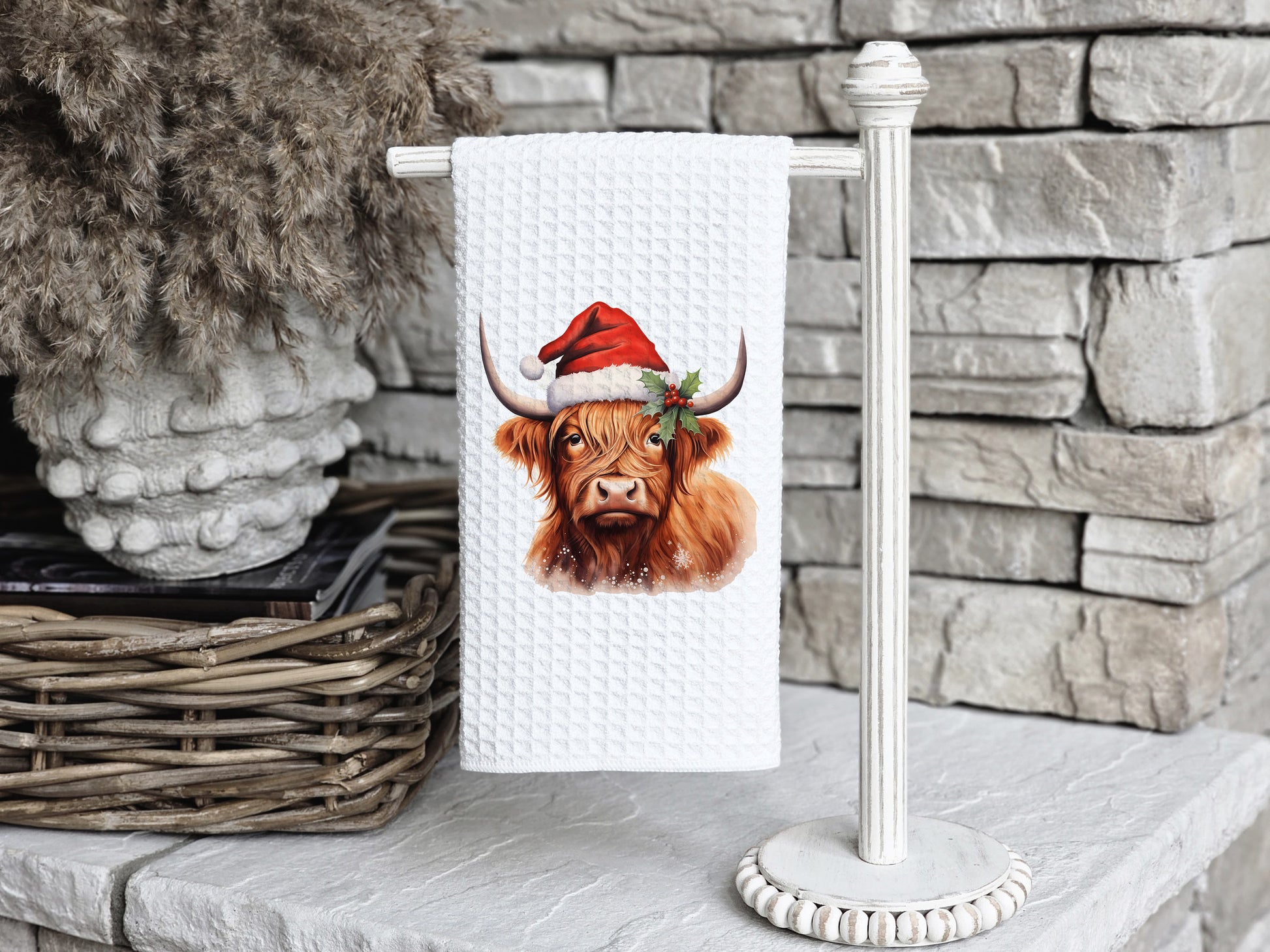 Highland Cow wearing a santa hat on a tea towel as a Christmas gift